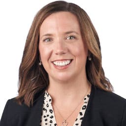 A headshot of associate Jennifer Atkinson. She has shoulder-length brown hair and is wearing a black blazer.