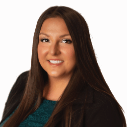 A headshot of associate Brittany Knight. She has long dark hair and she is wearing a green shirt.