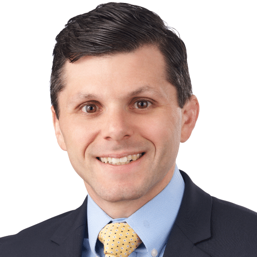 A headshot of associate Stephen Biggin. He has short dark hair and he is wearing a black blazer.