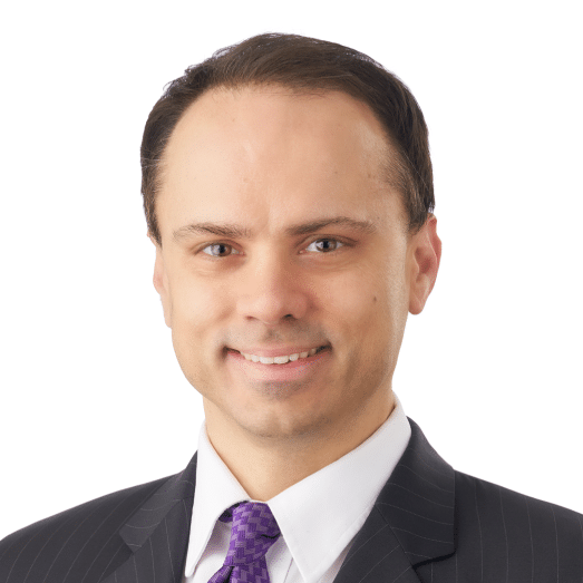 A headshot of associate Seth Dadds. He has short brown hair and he is wearing a pinstriped suit.