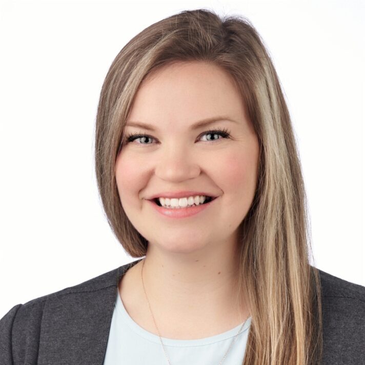 A headshot of associate Danielle Seningen. She has long blonde hair and is wearing a gray blazer.