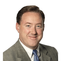 A headshot of associate James Hutchinson. He has short brown hair and is wearing an olive green suit.