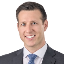 A headshot of associate Joseph Furey. He has short brown hair and is wearing a gray suit.