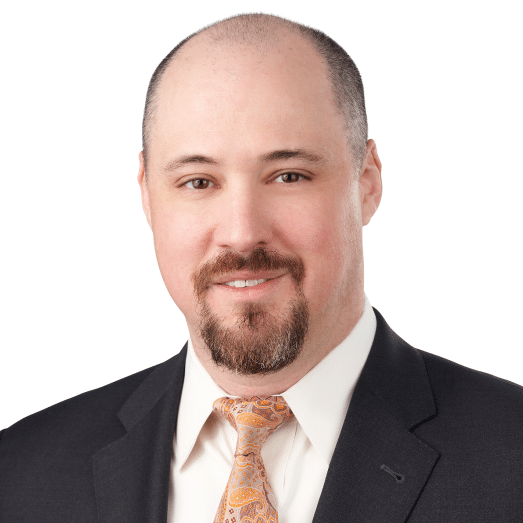 A headshot of associate Anthony Natale, CFA. He is smiling at the camera and wearing a black suit.