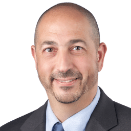 A headshot of associate Michael Paregian. He has short dark hair and he is wearing a black suit.