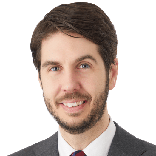 A headshot of associate Charles Posnecker, CFA, CFP, CTFA, AEP, CAP. He has short brown hair and he is wearing a gray suit.