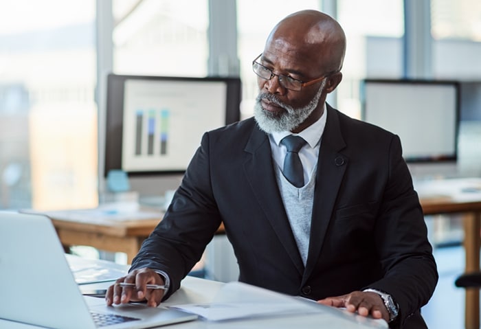 Shot of a mature businessman working on a laptop in an office