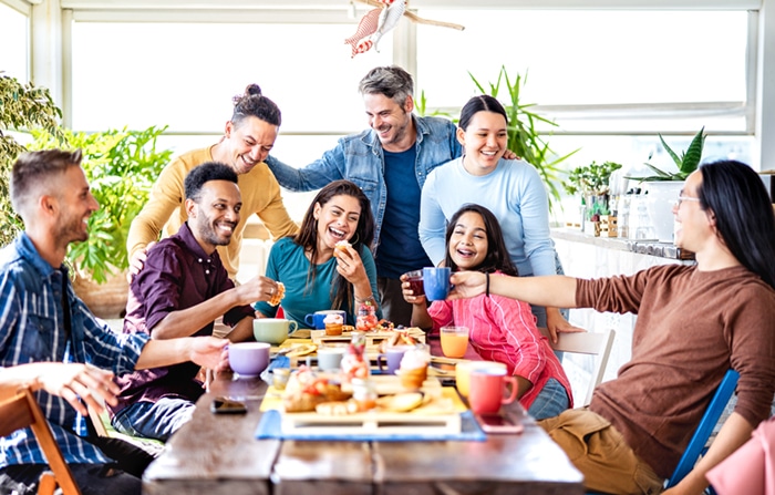 A family smiling around a dinner table.