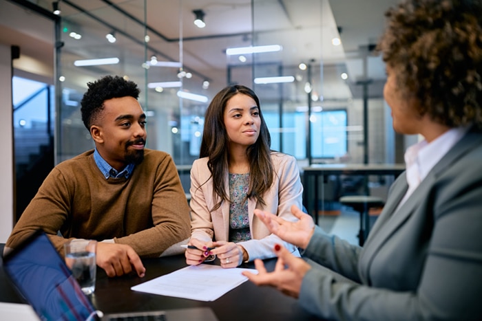 A man and a woman meeting with a banker.