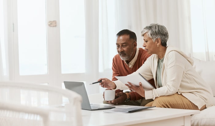 An older couple using a laptop.