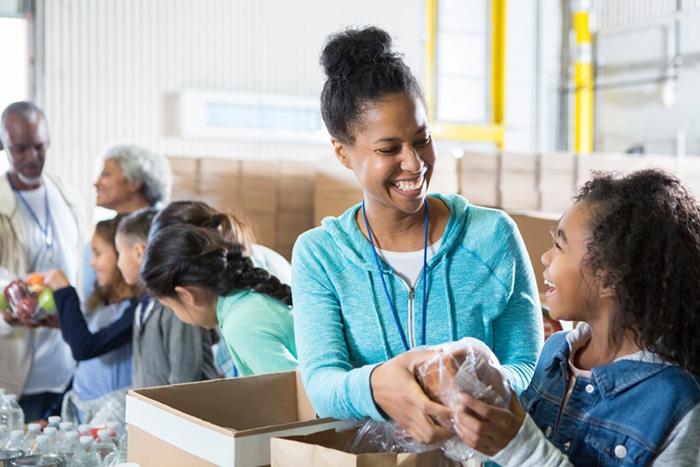 Volunteers packaging food.