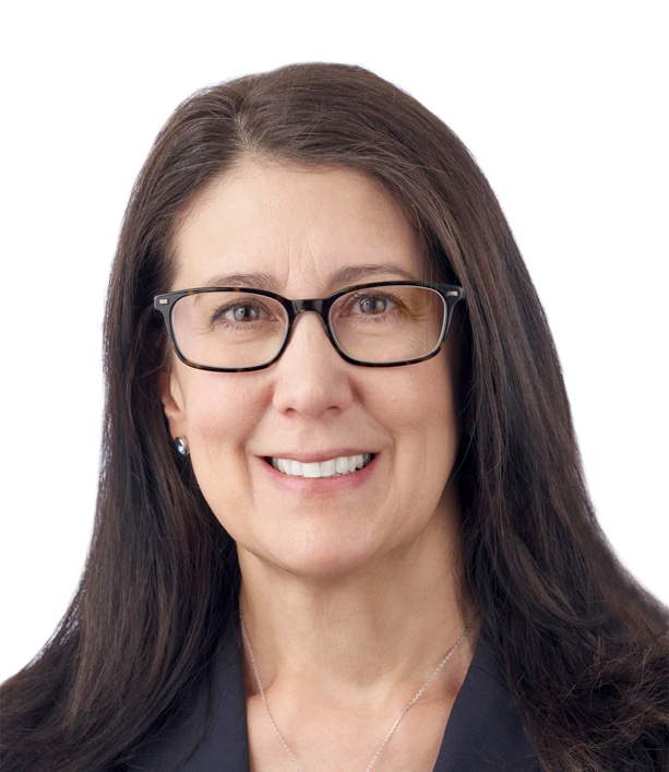 A headshot of associate Maria Quinn. She has long brown hair and is wearing tortoiseshell eyeglasses.