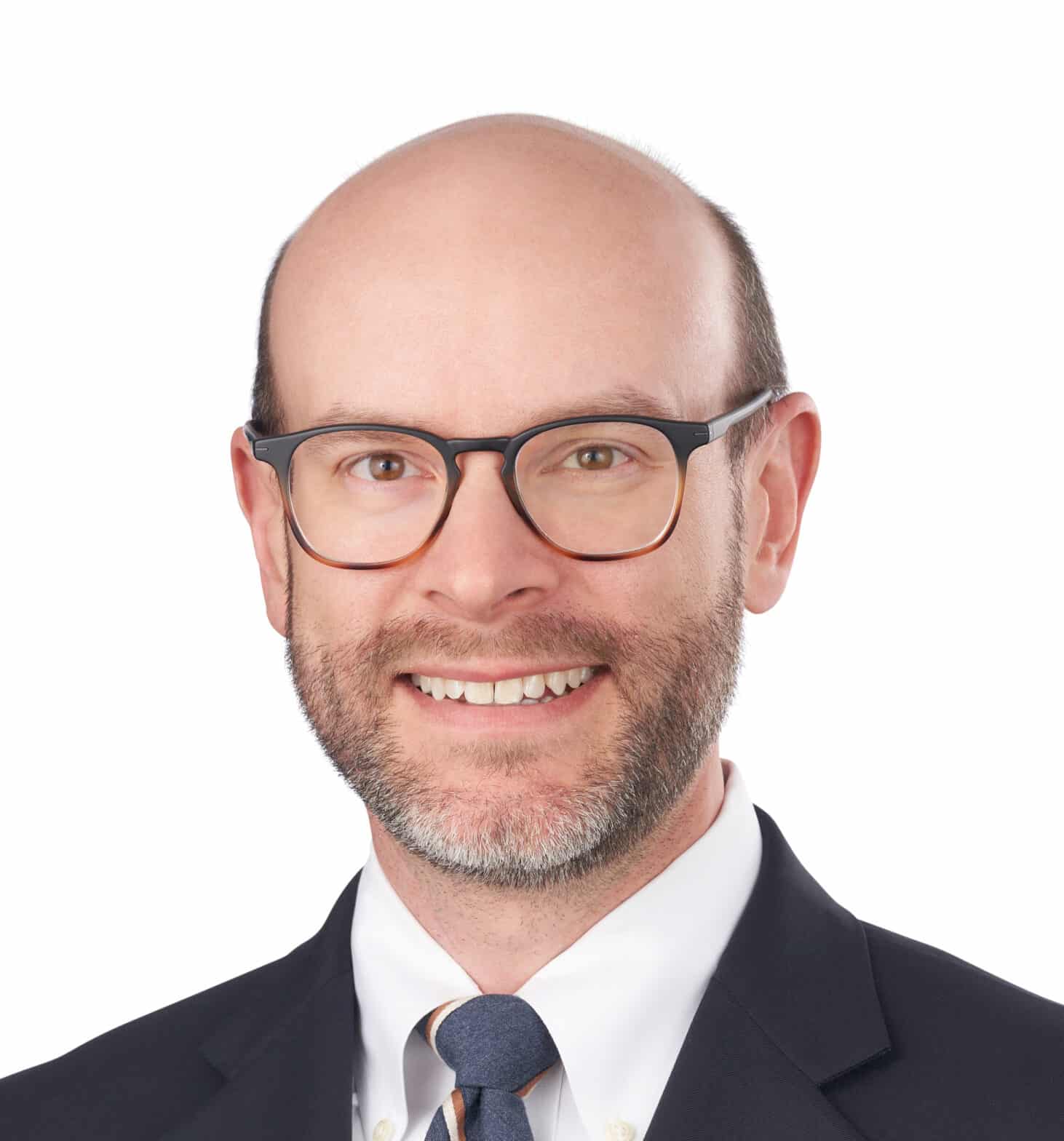 A headshot of associate Matthew Holt. He is wearing tortoiseshell eyeglasses and a black suit.