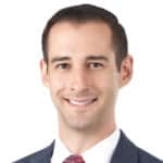 A headshot of associate Matthew Thornton. He has short brown hair and is smiling at the camera.