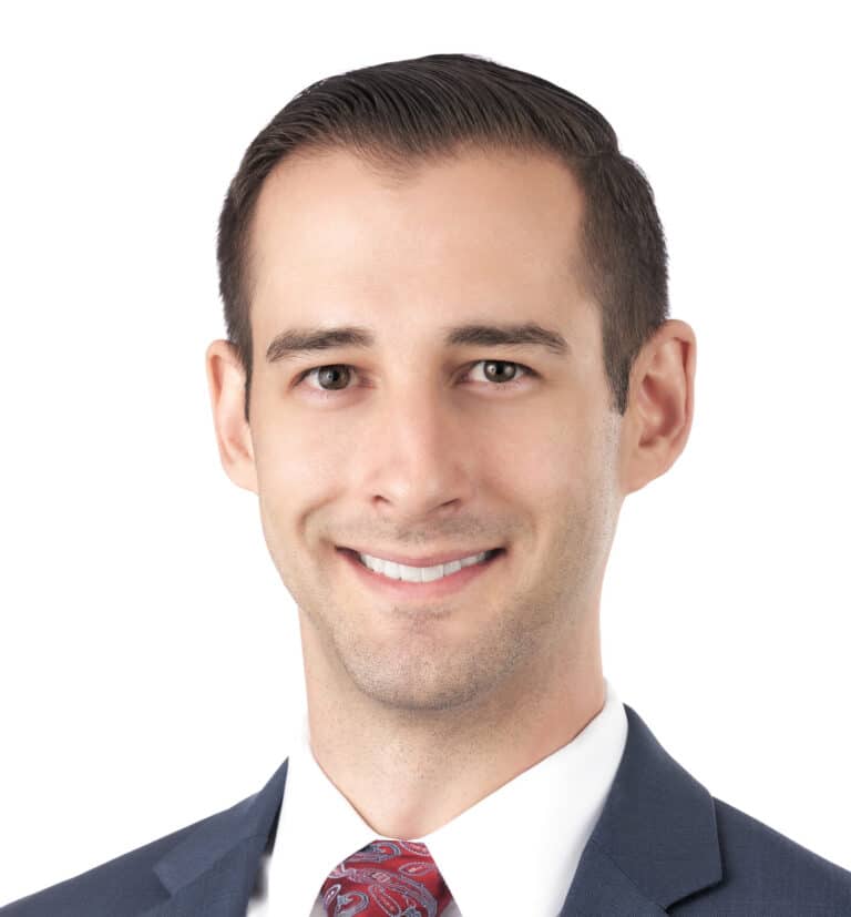 A headshot of associate Matthew Thornton. He has short brown hair and is smiling at the camera.