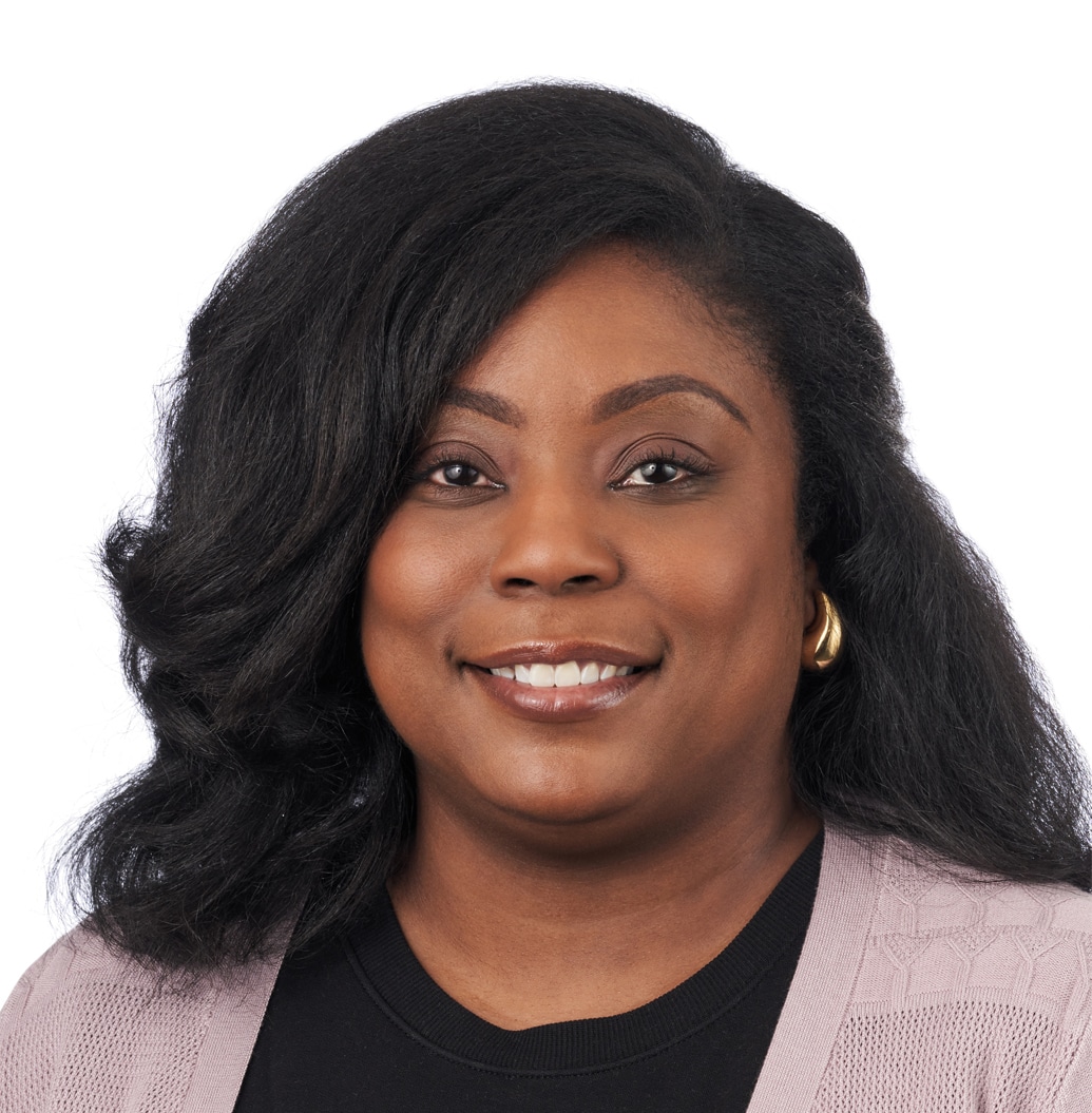 A headshot of associate Sherrita Sellers. She has long black hair and is wearing a tan cardigan sweater.