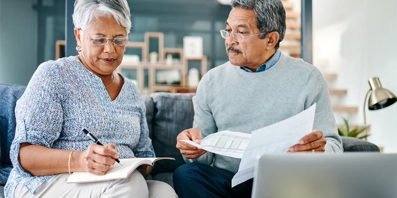 A woman and a man filling out paperwork together.